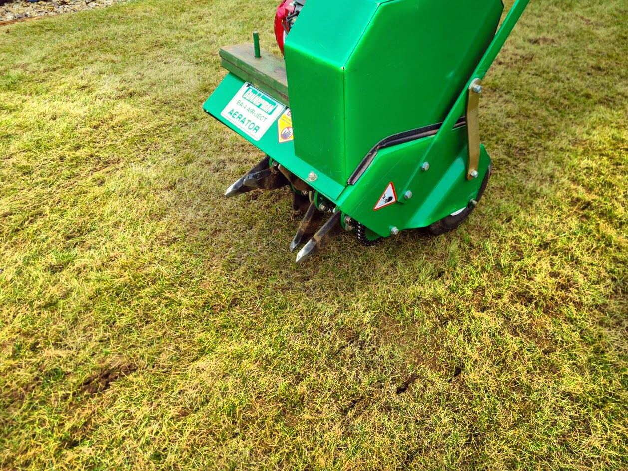 Lawn aeration machine in use
